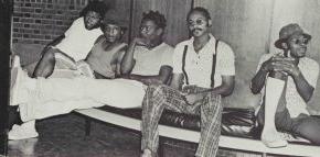 Five male students sit together in a 1974 black 和 white photo