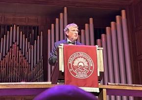 Fred K. Whitt at the podium presenting Diamond Award