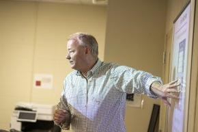 Bjarne Berg teaching in front of a screen in a classroom