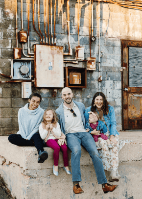 Rachel Tenny poses outside for a photo with her two daughters, husband and au pair while outside