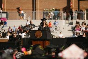 金伯利奶奶 stands behind the podium onstage in Moretz Stadium