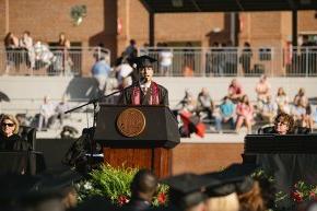 迭戈Sanjuan speaks behind the podium on stage in Moretz Stadium