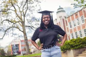 Kiera Elliott standing in front of the Rhyne Building