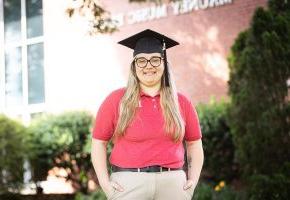 Tiffany Holman stands in front of Mauney Music Building