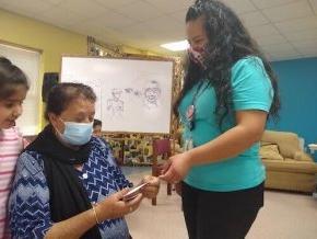 A student speaks with a member of her community.