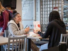 学生 eating Chick-fil-A at the new campus restaurant