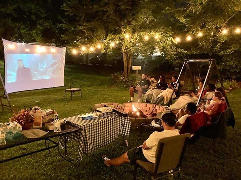 International students enjoying a cookout and movie under the stars.