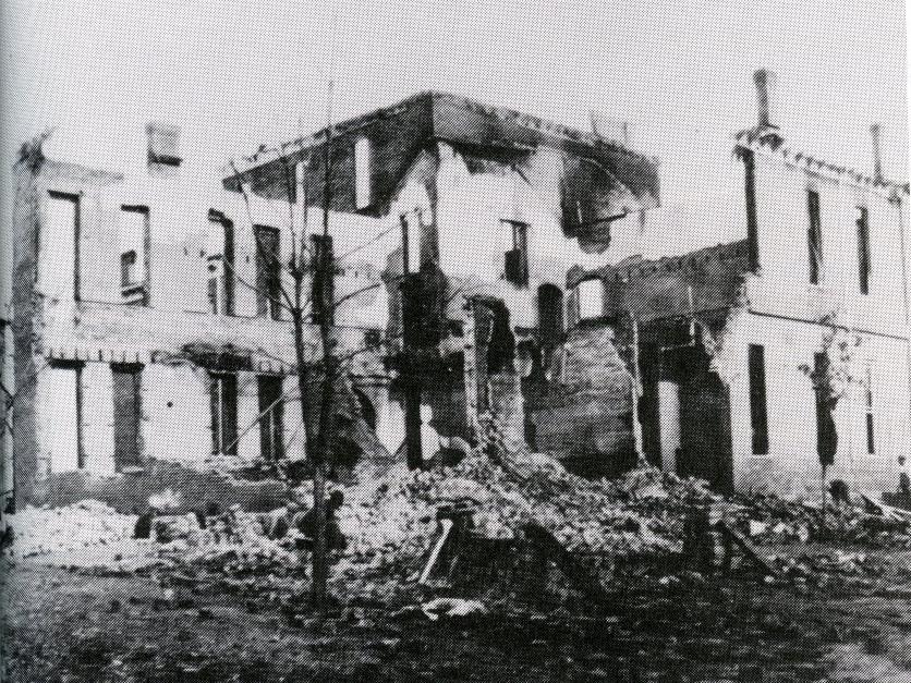 A black and white archive photo of a campus building in the 1900s