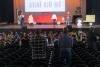 A group of children watch a play on a stage